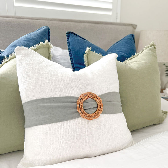 White and sage cushion with rattan buckle. Perfect for a coastal or classic style home. White and sage Cushion covers 50x50 - Square cushion