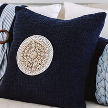Load image into Gallery viewer, Navy blue coastal cushion with a rattan and shell disk, the perfect beach pillows for your coastal home.

