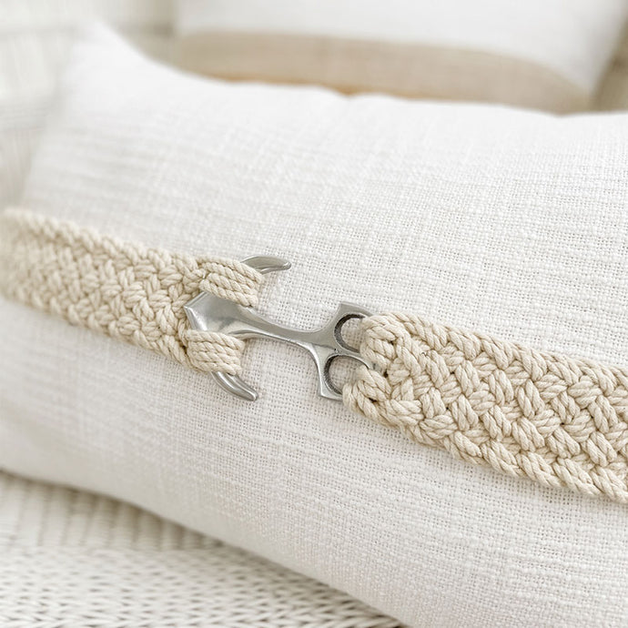 Nautical cushion featuring an anchor accent, perfect for a coastal home. 