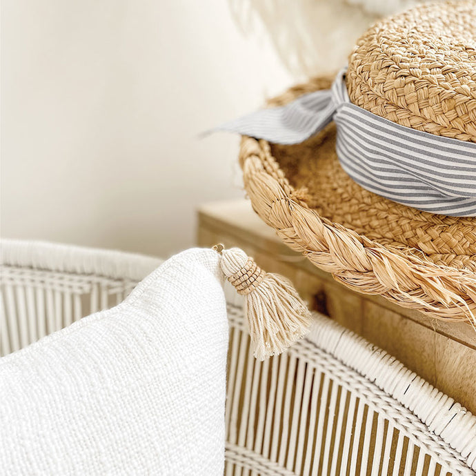 The white cushion with timber beaded tassels are part of our coastal and Hamptons range. 50x50 cushion cover