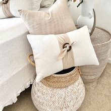 Load image into Gallery viewer, white 100% cotton cushion cover with the option of a generous feather insert. Wrapped around the cushion is a stone colour Buckle Sash and small Timber Buckle. Classic style cushion
