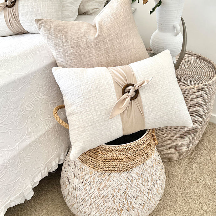 white 100% cotton cushion cover with the option of a generous feather insert. Wrapped around the cushion is a stone colour Buckle Sash and small Timber Buckle. Classic style cushion